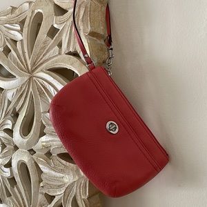 Never used 8” Coach wristlet in coral color.